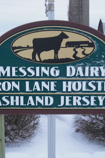 The farm sign that is near the driveway at my family's dairy farm.