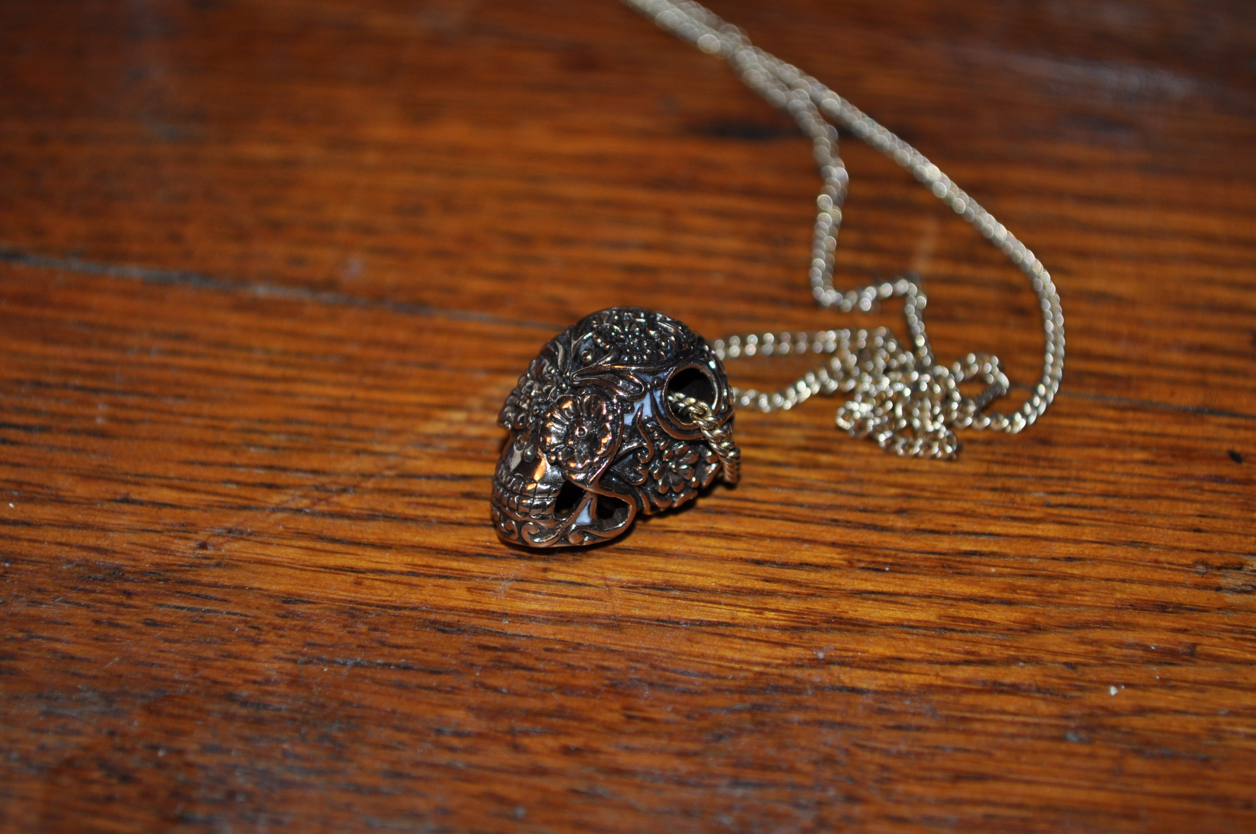 Here is my photo of my necklace, I couldn't get the lighting quite right but it is more of a gold/bronze than the picture shows.